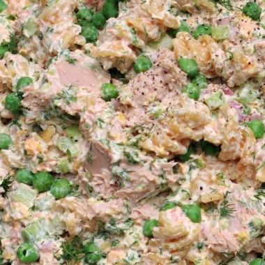 A vibrant bowl of Tuna Pasta Salad with colorful vegetables and a creamy dressing.