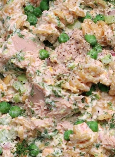 A vibrant bowl of Tuna Pasta Salad with colorful vegetables and a creamy dressing.