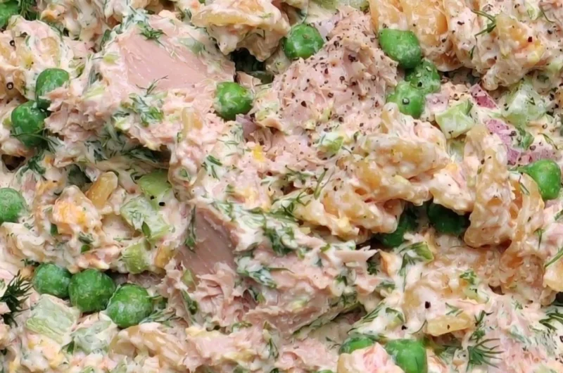 A vibrant bowl of Tuna Pasta Salad with colorful vegetables and a creamy dressing.