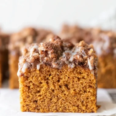 Delicious pumpkin cake topped with crumb and maple cream cheese glaze