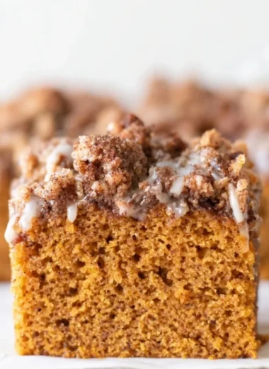 Delicious pumpkin cake topped with crumb and maple cream cheese glaze