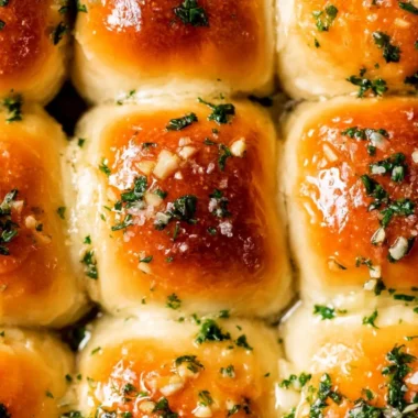 Freshly baked garlic bread rolls with herbs and butter