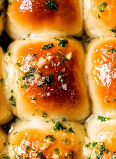 Freshly baked garlic bread rolls with herbs and butter
